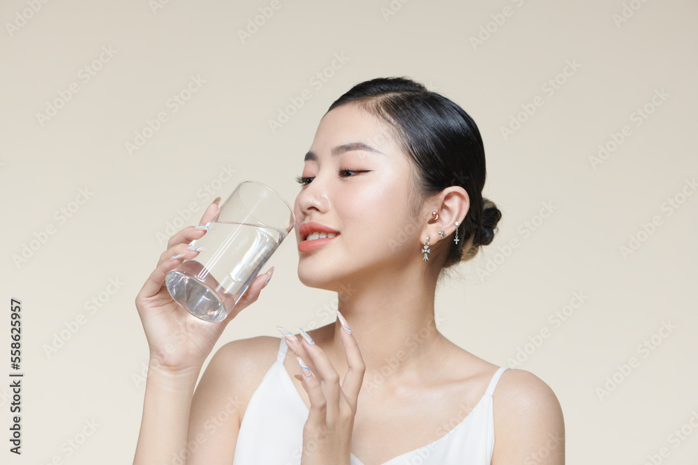 pretty young woman drinking water from glass