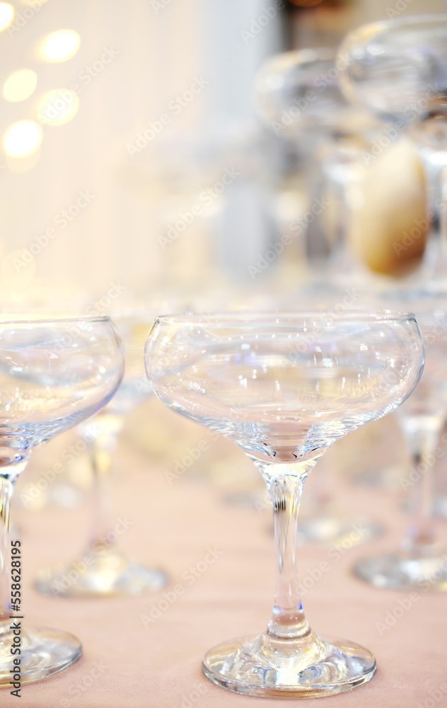Pyramid of empty champagne glasses against golden bokeh background Pyramid of empty champagne glasses against golden bokeh background