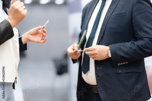 Business people exchanging business card on business meeting  Business discussion talking deal concept.