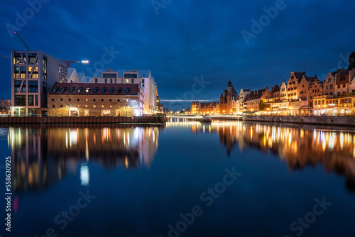 Old town in Gdansk with historical architecture by the Motlawa river at night, Poland.