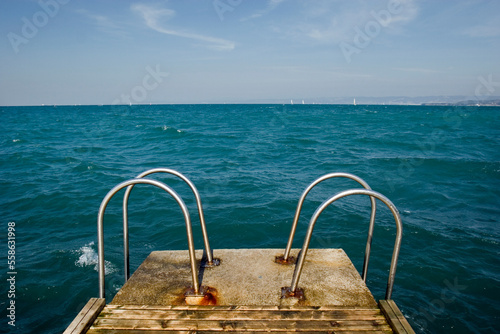 Pool ladders submerge in the sea, Izola, Slovenia. photo