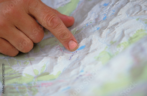 A woman finds the best way for her team to navigate through the next stretch of an adventure race. photo