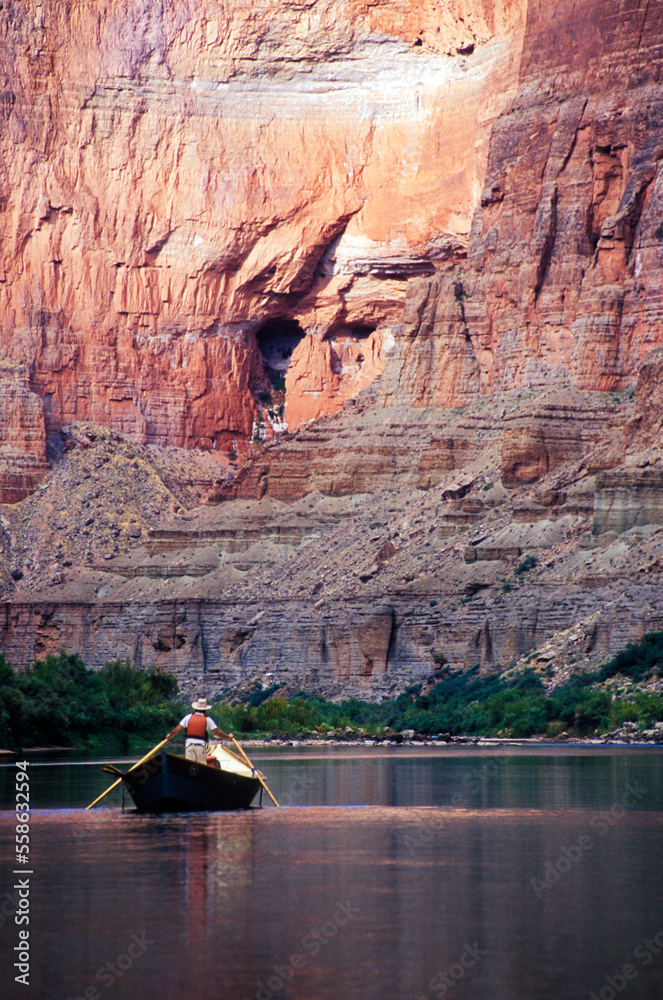 © Cavan Images - A river guide rowing a wooden dory downstream, Grand Canyon National Park, Arizona.