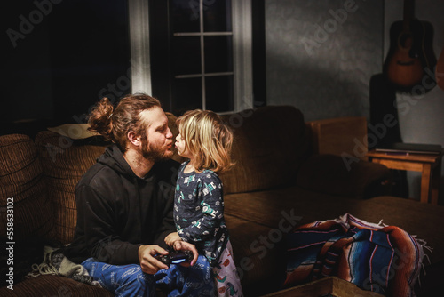 Little boy kissing his dad goodnight