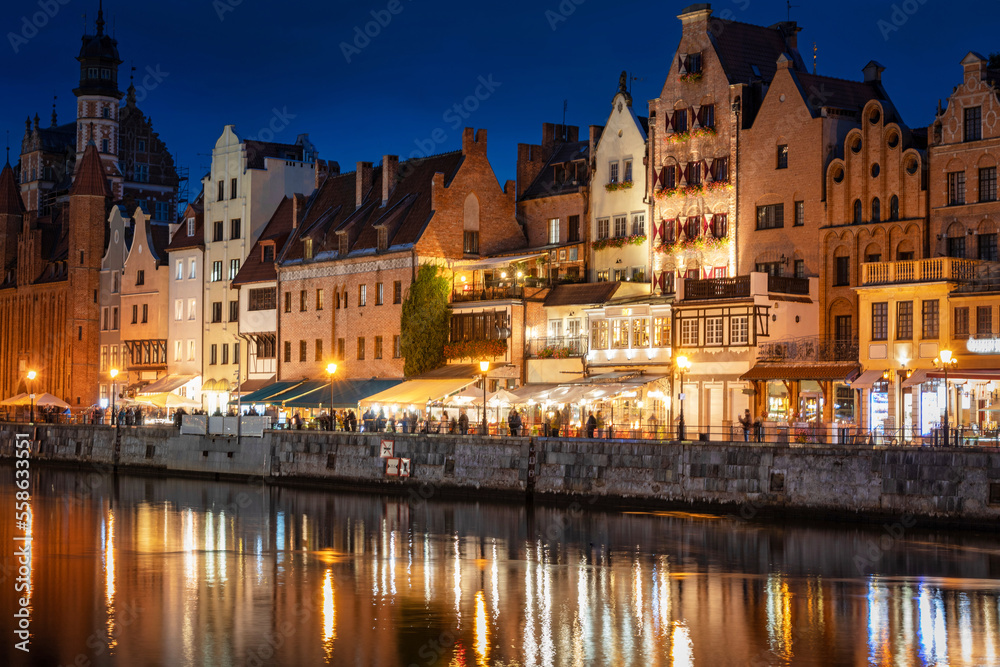 Old town in Gdansk with historical architecture by the Motlawa river at night, Poland.