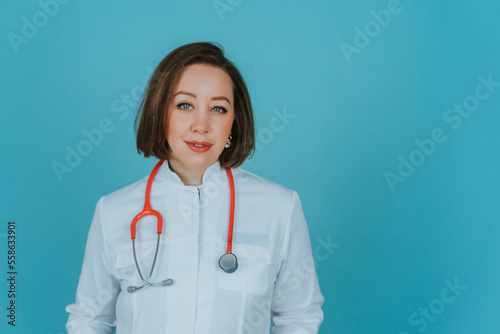 Woman doctor in white coat on blue background