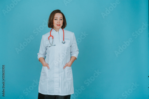 Woman doctor in white coat on blue background