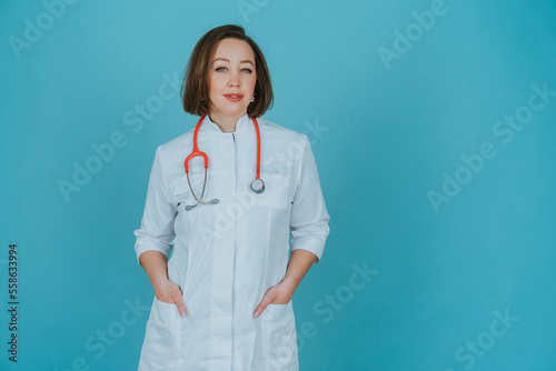 Woman doctor in white coat on blue background