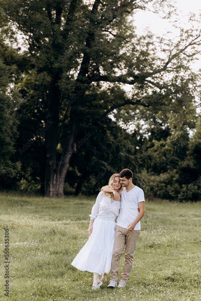 young happy couple running hand in hand in the countryside. young family concept. copy space young happy couple running hand in hand in the countryside. young family concept. copy space