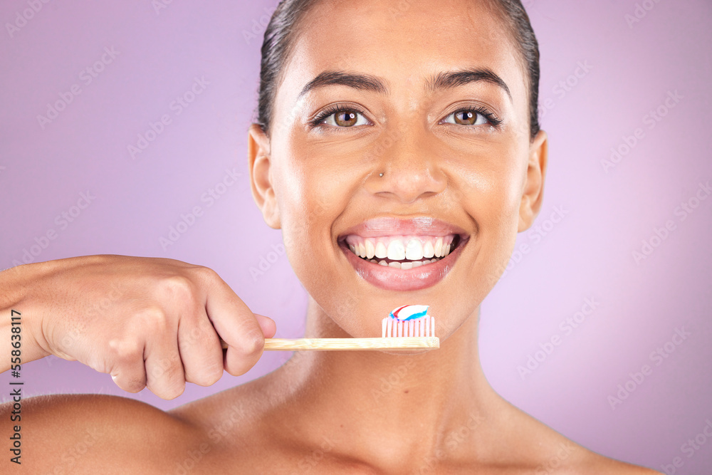 Woman, smile and toothbrush in studio portrait with self care, beauty and toothpaste for hygiene. Black woman, teeth and cleaning with organic wood brush, happy and self love by purple background Woman, smile and toothbrush in studio portrait with self care, beauty and toothpaste for hygiene. Black woman, teeth and cleaning with organic wood brush, happy and self love by purple background