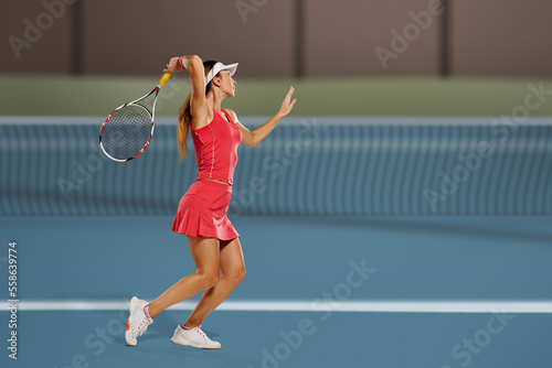 Athletic happy sporty woman hitting ball during tennis match © Denys Kurbatov