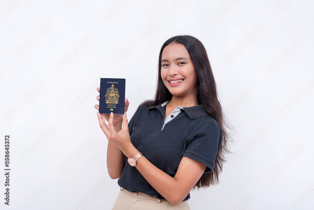 A happy asian woman proudly presents her newly acquired US passport. Isolated on a white background. A happy asian woman proudly presents her newly acquired US passport. Isolated on a white background.