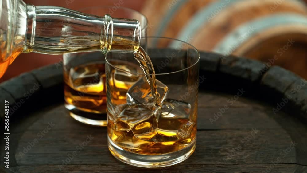 Super slow motion of pouring whisky into glass. Filmed on high speed cinema camera, 1000 fps. Super slow motion of pouring whisky into glass. Filmed on high speed cinema camera, 1000 fps.