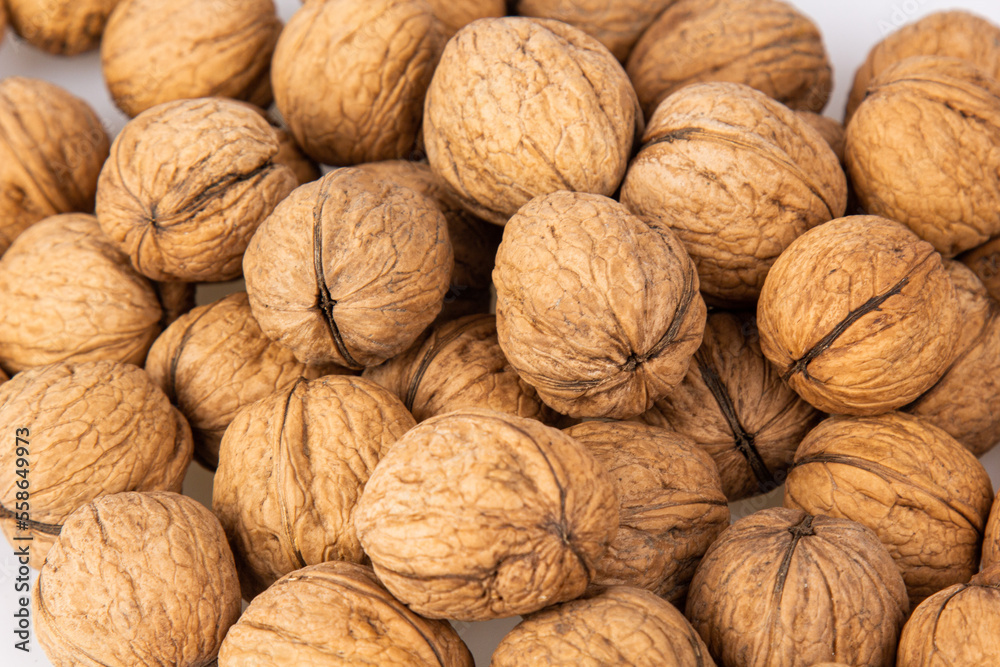 Walnut in shell isolated on white background. Energy boost for the day. The concept of proper nutrition. Tasty breakfast. Walnut in shell isolated on white background. Energy boost for the day. The concept of proper nutrition. Tasty breakfast.