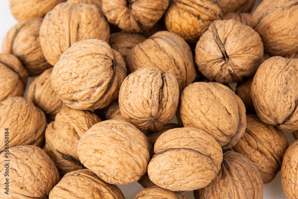 Walnut in shell isolated on white background. Energy boost for the day. The concept of proper nutrition. Tasty breakfast. Walnut in shell isolated on white background. Energy boost for the day. The concept of proper nutrition. Tasty breakfast.