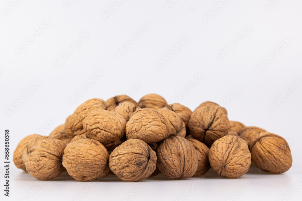 Walnut in shell isolated on white background. Energy boost for the day. The concept of proper nutrition. Tasty breakfast. Walnut in shell isolated on white background. Energy boost for the day. The concept of proper nutrition. Tasty breakfast.