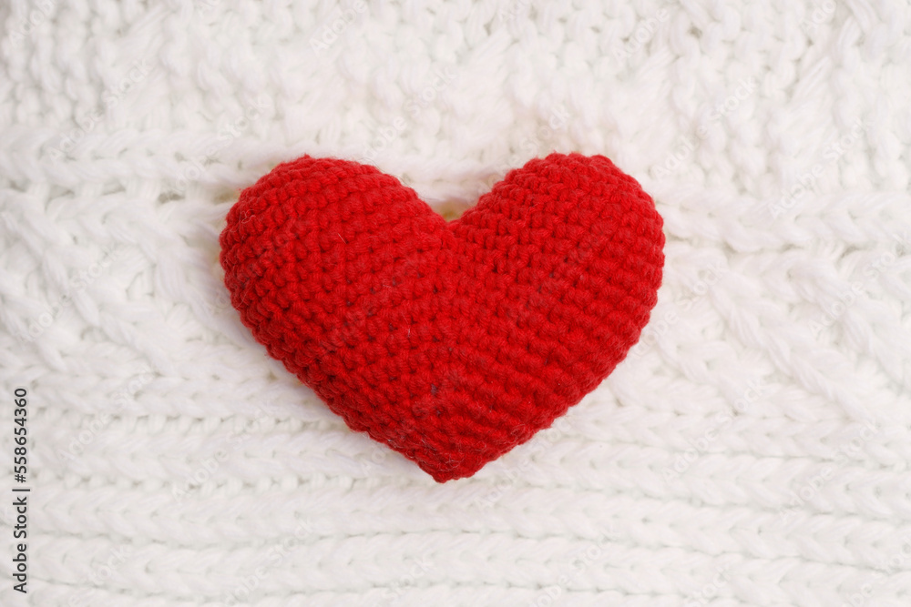 red knitted heart on a white woolen scarf