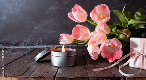 Bouquet of pink tulips on rustic wooden planks. Background still life for mother's day and women's day concepts. photo