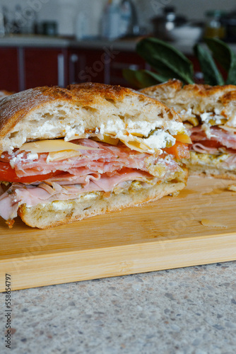 homemade sandwich with salami, ham, tomatoes and cheese