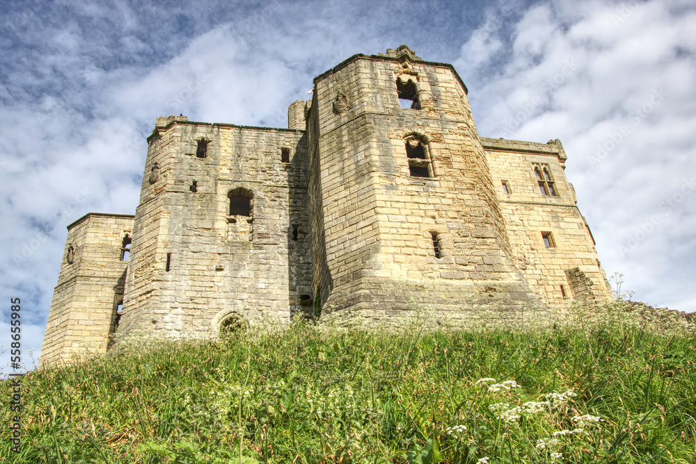 warkworth castle with blue sky in the background