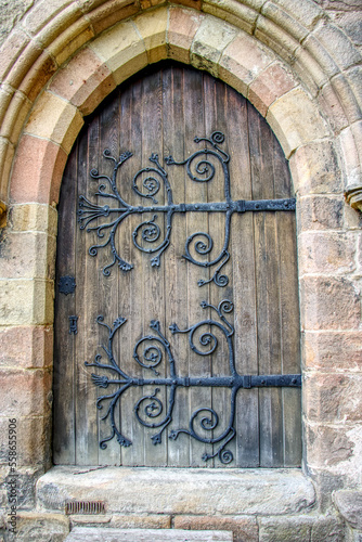 wooden abbey door with iron work
