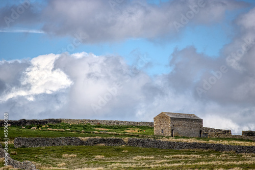 stone building with Yorkshire Dales United Kingdom in the background