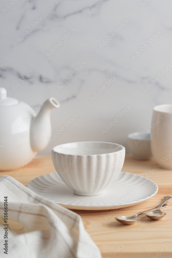 Empty tableware - white plate, a bowl and a cup on wooden table as a background for a dish foodbackground Empty tableware - white plate, a bowl and a cup on wooden table as a background for a dish foodbackground