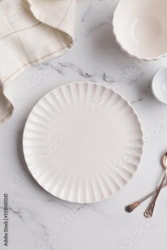 Fotografi Empty tableware - white plate a bowl and a cup on white table as a background fo