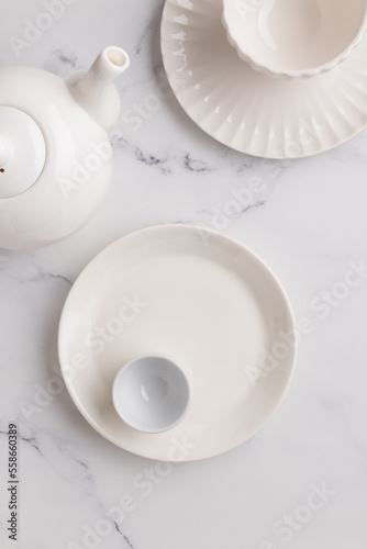 Empty tableware - white plate a bowl and a cup on white table as a background for a dish foodbackground