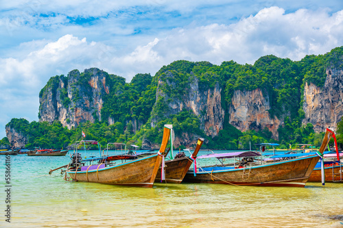 Long tail boats at Railay beach, Krabi, Thailand. Tropical paradise, turquoise water and white sand.