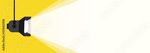 Banner spotlight background. Retro spotlight is glowing on wall. Spotlight on color background. Illuminated lamp advertising poster space for text. Spotlight shining on yellow background. Web banner