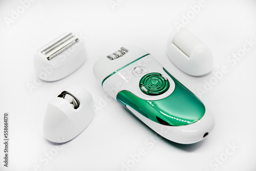 Women's electric razor for intimate places. A set of women's razor for hair on a white background. A white electric razor.