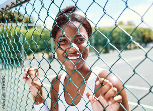 Fitness, fence or portrait of black woman on a tennis court relaxing on training, exercise or workout break in summer. Happy, sports athlete or healthy African girl ready to play a fun match or game