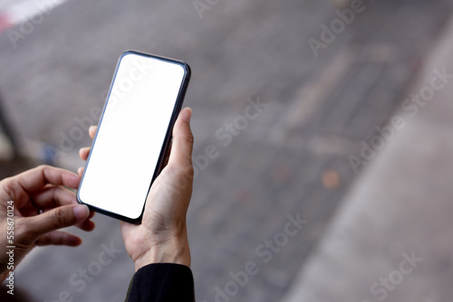 cell phone blank white screen mockup.hand holding texting using mobile on desk at office.background empty space for advertise.work people contact marketing business,technology