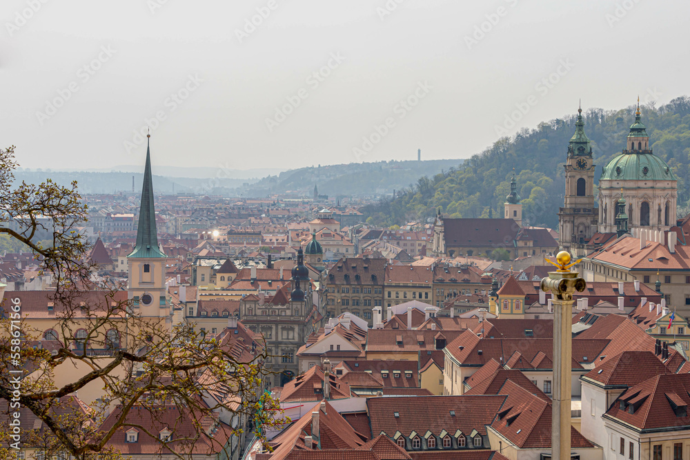 Scenic aerial view of the old town square under cloudy sky, Overview of architecture houses with orange brick rooftop of buildings, The City of a Hundred Spires, Prague capital of the Czech Republic.