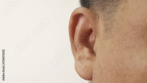 Close-up of ear, Asian man with hearing problems, congenital deafness