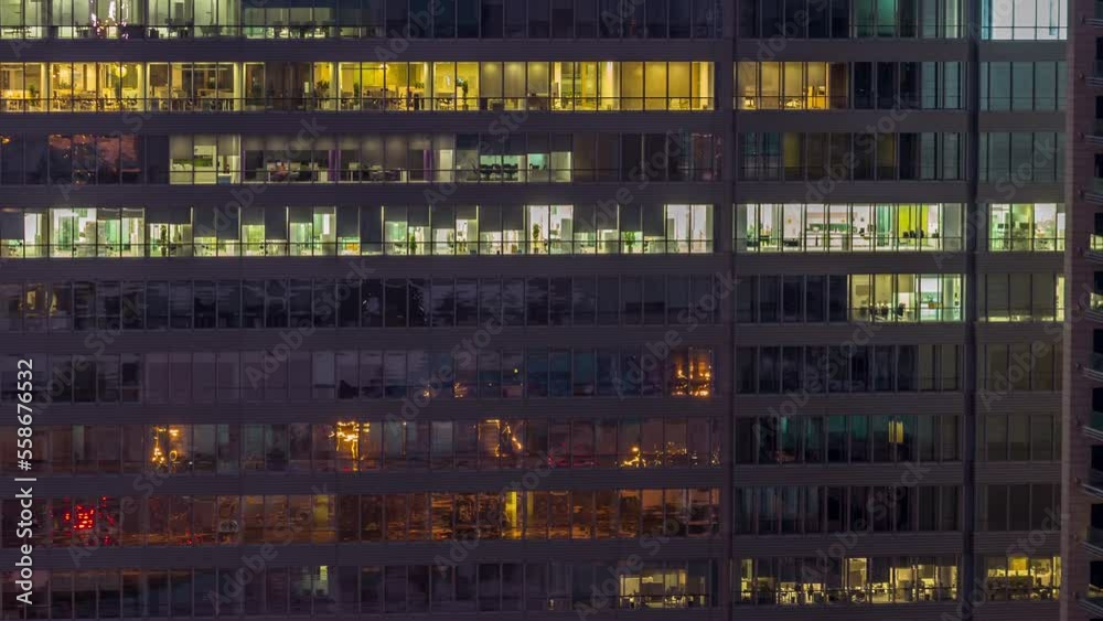 Windows of office buildings night to day transition timelapse, the light from the windows of skyscrapers turning off at morning. Landscape of the city with glowing working space Windows of office buildings night to day transition timelapse, the light from the windows of skyscrapers turning off at morning. Landscape of the city with glowing working space