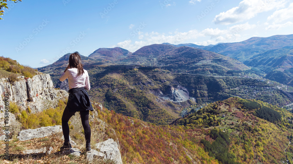 Traveler Woman standing on a rocks  in the autumn  mountain . Balkan mountains,  ,Bulgaria
