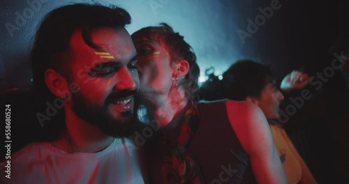 Close up of a young man in makeup in red light photo