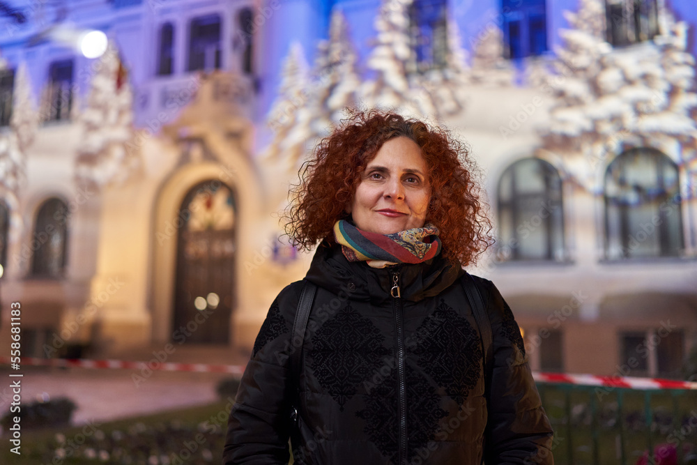 Curly red haired woman, night city portrait Curly red haired woman, night city portrait