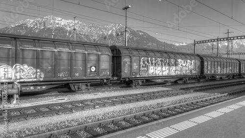 Freight train with graffiti in black and white
