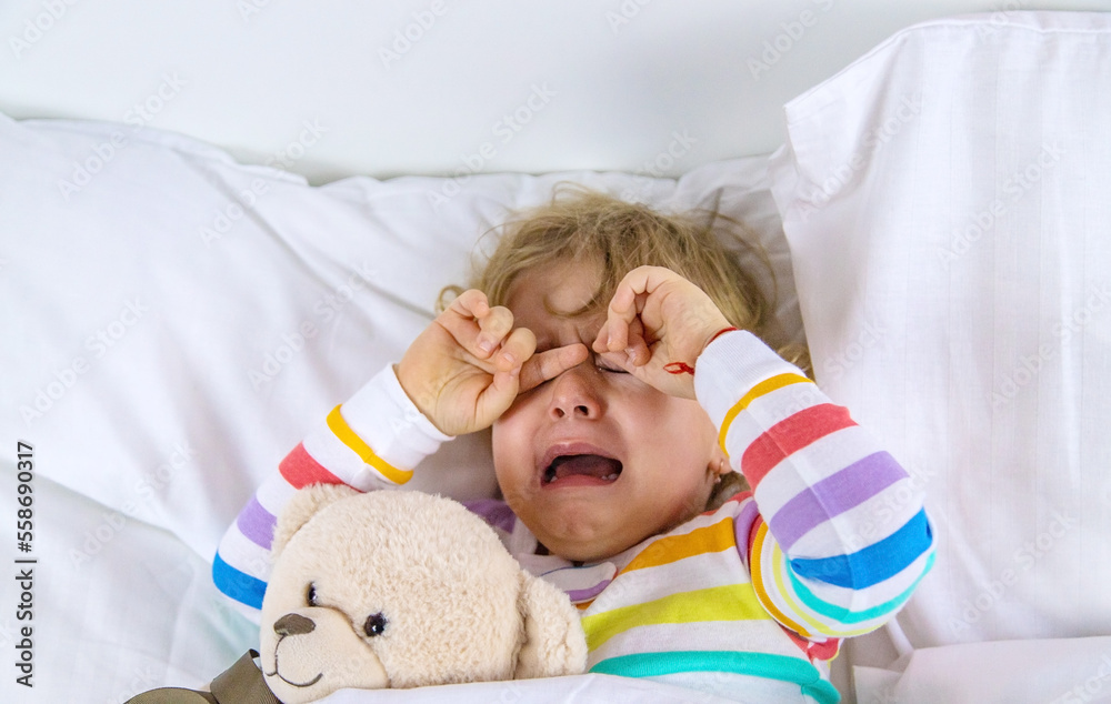 Children are crying in bed. Selective focus. Children are crying in bed. Selective focus.