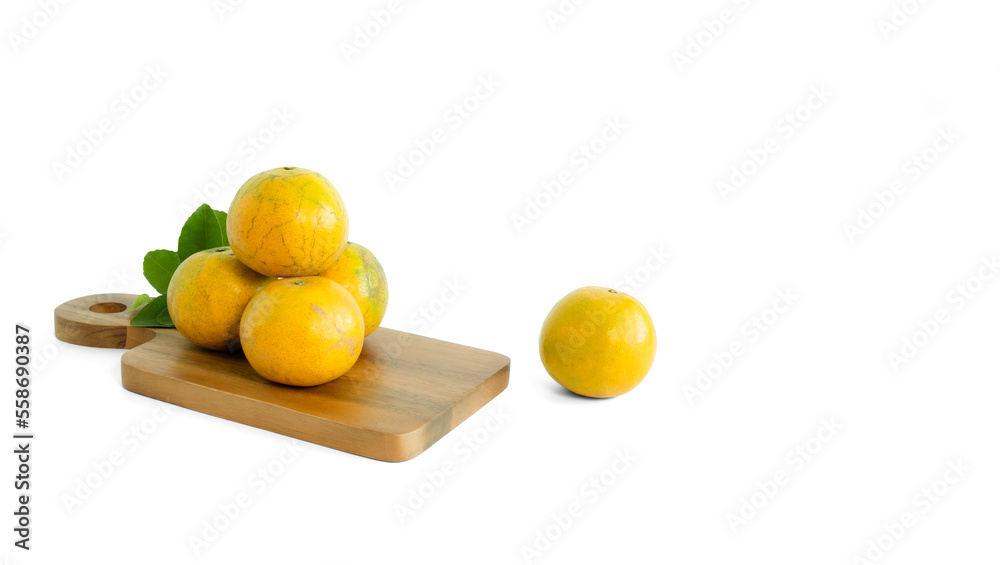 Fresh organic tangerine (shogun) orange fruit with green leaves placed on a wooden cutting board. isolated on white background Fresh organic tangerine (shogun) orange fruit with green leaves placed on a wooden cutting board. isolated on white background