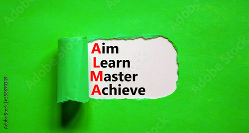 ALMA aim learn master achieve symbol. Concept words ALMA aim learn master achieve on white paper on beautiful green background. Business ALMA aim learn master achieve concept. Copy space.