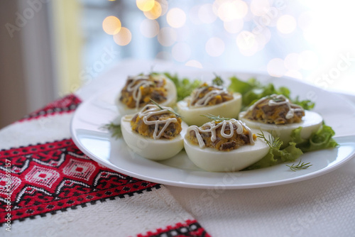 Obraz na płótnie Deviled eggs aka stuffed eggs. Traditional Ukrainian food on the table with embroidered tablecloth. w salonie