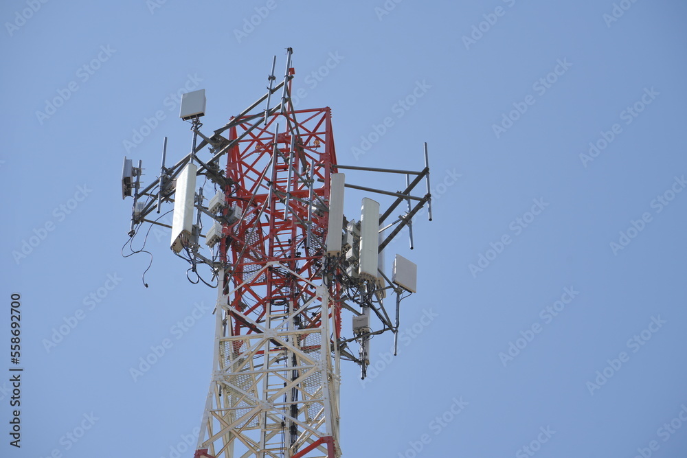 custom made wallpaper toronto digitalTelecommunication tower of 4G and 5G cellular. Macro Base Station. 5G radio network telecommunication equipment with radio modules and smart antennas mounted on a metal against blue sky background.