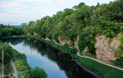 Creswell Crags prehistoric site. Caves both sides limestone gorge occupied 43,000 years from last Ice Age to 10,000 years ago. View E along S cliffs