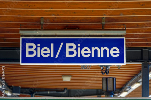 Blue and white sign at wooden ceiling of platform roof on a sunny autumn day. Photo taken November 10th  2022  Biel Bienne  Switzerland.