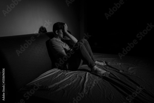 Man with depression sitting in a dark room.  Depression is a low mood that lasts for a long time  and affects your everyday life.