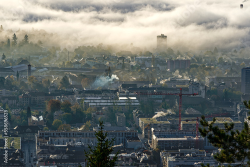 Aerial view over Swiss City of Biel Bienne, Canton Bern, seen from village Evilard on a sunny foggy autumn morning. Photo taken November 10th, 2022, Evilard, Switzerland.